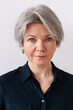 © Viktor Solomin/Stocksy - Portrait of a woman with short gray hair and blue eyes
