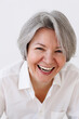 © Viktor Solomin/Stocksy - Joyful older woman laughing while interacting indoors
