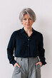 © Viktor Solomin/Stocksy - Portrait of a confident woman with gray hair