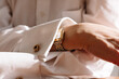 © Viktor Solomin/Stocksy - Elegant wristwatch displayed on a person's cuffed shirt