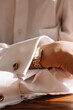 © Viktor Solomin/Stocksy - Elegant wristwatch visible under a crisp white shirt sleeve