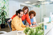 © Santi Nuñez/Stocksy - Business team collaborating on computer project in modern office
