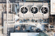 © Lawren Lu/Stocksy - Industrial Facility with Large Fans and Piping System