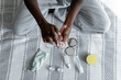 © Atolas/Stocksy - Young woman hands using skincare products