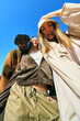 © Javier Díez/Stocksy - Friends posing together outdoors in casual fashion on a sunny da