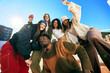 © Javier Díez/Stocksy - Friends enjoying a sunny day on a rooftop in an urban setting