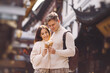 © prostooleh - newlywed couple eating ice cream from a cone on a street in Shanghai near Yuyuan China.