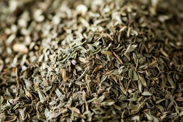 Poster - Dried herbs piled on a surface showcasing their rich texture and vibrant color at a kitchen countertop