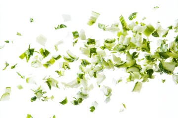 Aufkleber - Chopped green vegetables flying in the air against a white background during meal preparation in a kitchen