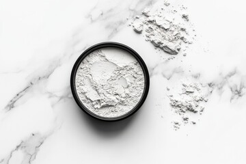 Poster - White powder in a black bowl on a marble surface, showcasing texture and detail under natural light in a kitchen setting