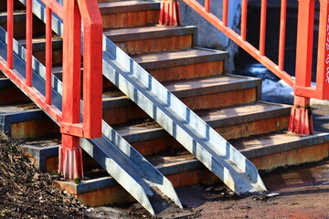 Poster - Close-up view of a staircase with bold red railings, suitable for interior design or architecture-related images.