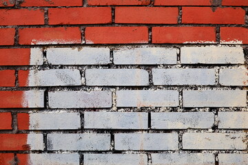 Aufkleber - A red and white brick wall with a white line painted on it.