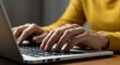 © Firman Dasmir - Close-up of hands typing on a laptop, showcasing productivity and technology
