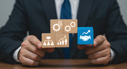 Poster - Man Presenting Wooden Blocks Displaying Growth Strategy and Business Success in a Dark Suit on a Wooden Table