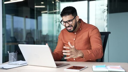Worried disappointed businessman having problems with software or service on laptop computer sitting at workplace in business office. Frustrated angry man complains about bad internet connection