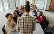 © Jacob Lund - Female leading her team during a business training session with diverse professionals in a large boardroom setting