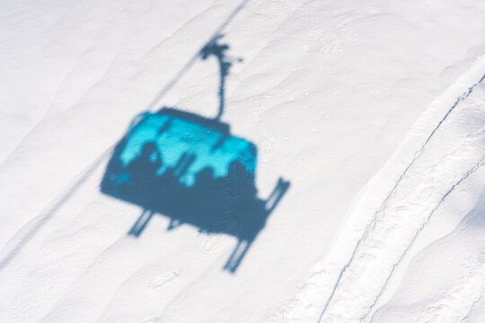 Photo of ski lift shadow on snow