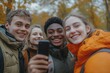 © Vision Quest - Group of smiling international teenage friends taking a selfie with Mobile cell in an urban park in autumn. Erasmus classmates using phone to upload content to social, Generative AI
