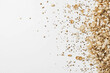 © ZaheerUDin - Close-up top view of scattered brown rice grains on a white background, highlighting the natural texture and earthy tones of the rice for food photography or culinary design