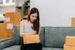© NINENII - small business entrepreneur SME or freelance asian woman working with box at home.
