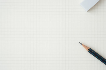 Wall Mural - top view, close-up of pencil and eraser on graph paper background, copy space for text, flat lay con