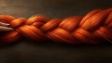 A vibrant, detailed braid of fiery orange hair