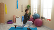 © Krakenimages.com - Young man doing lunges indoors at a gym surrounded by exercise equipment, demonstrating a focused workout routine in a well-lit sports center.