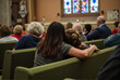 © Musicman80 - People Sitting in Church Pews with Comforting Embrace