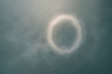 Poster - Smoke ring floats gracefully in mid-air, its swirling form creating a perfect circle against a softly blurred background, evoking a sense of ethereal beauty and fleeting artistry