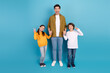 © deagreez - Happy father with two cheerful children making peace signs against blue background, embodying fun, love, and family bonding