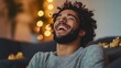 © Rattanachai - Man Laughing Joyfully Indoors With Warm Lighting