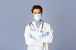 © Prostock-studio - Confident Indian doctor wearing medical mask and rubber gloves on lilac background