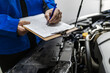 © zphoto83 - Mechanic conducting vehicle inspection with clipboard and checklist in automotive workshop