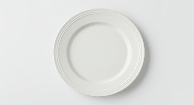 a minimalist white plate on a clean background, ideal for displaying food or portraying the lack the