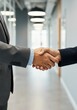 © Passion - Business handshake in office hallway symbolizing partnership and agreement