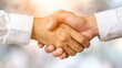 © CrazyJuke - A closeup of a firm handshake symbolizes partnership and trust between professionals in a blurred, elegant background.