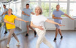 © JackF - Portrait of active mature people enjoying modern energetic dancing in a group in the studio