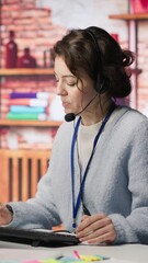 Poster - vertical video worker providing live chat support, typing on keyboard, handling clients complaints. 