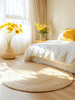 © Lala Farikha - Sunlit bedroom with round jute rug, white bedding, and yellow sunflowers