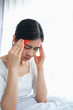 © Ton Photographer4289 - Young woman touching her temples with her hand because of severe headache due to stress or migraine. Health and mental health problem concept.