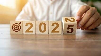 Poster - Wooden blocks spelling out a year with a target symbol and a person in the background blurred