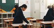© peopleimages.com - Student, child and cleaning desk at school for hygiene, learning responsibility and discipline in classroom. Japanese academy, people and wipe surface for disinfection, germs prevention and values