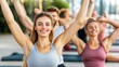 © Anuphong - Smiling People in a Group Yoga Class Outdoors