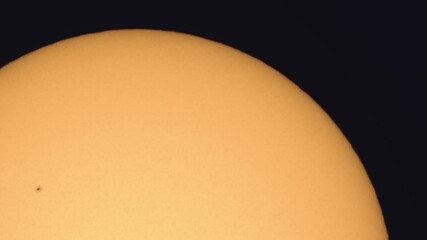 Wall Mural - surface of the sun through telescope with visible sunspots and surface texture and atmosphere turbul