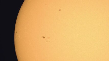 Wall Mural - surface of the sun through telescope with visible sunspots and surface texture and atmosphere turbul