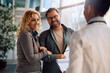© Drazen - Happy woman and her husband talking to general practitioner at doctor's office.