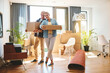 © CamPen2000/peopleimages.com - Mature, boxes and new home or moving out with living room, property or real estate support, help and excited. Happy people and carry cardboard for boxing, furniture or relocation with movers services