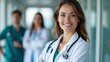 © Gayan - Friendly Doctor With Colleagues In Background