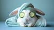 © Songsak - Relaxing Bunny with Cucumber Slices and Soft Towel in Spa Setting