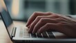 © Tania - Close-up of hands typing medical notes on a laptop